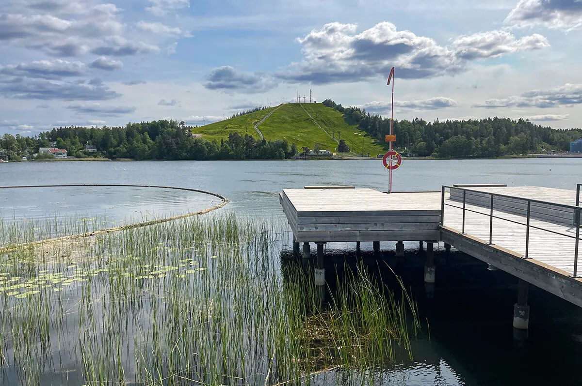Lake Väsjön on a summer’s day, with a jetty and reeds.