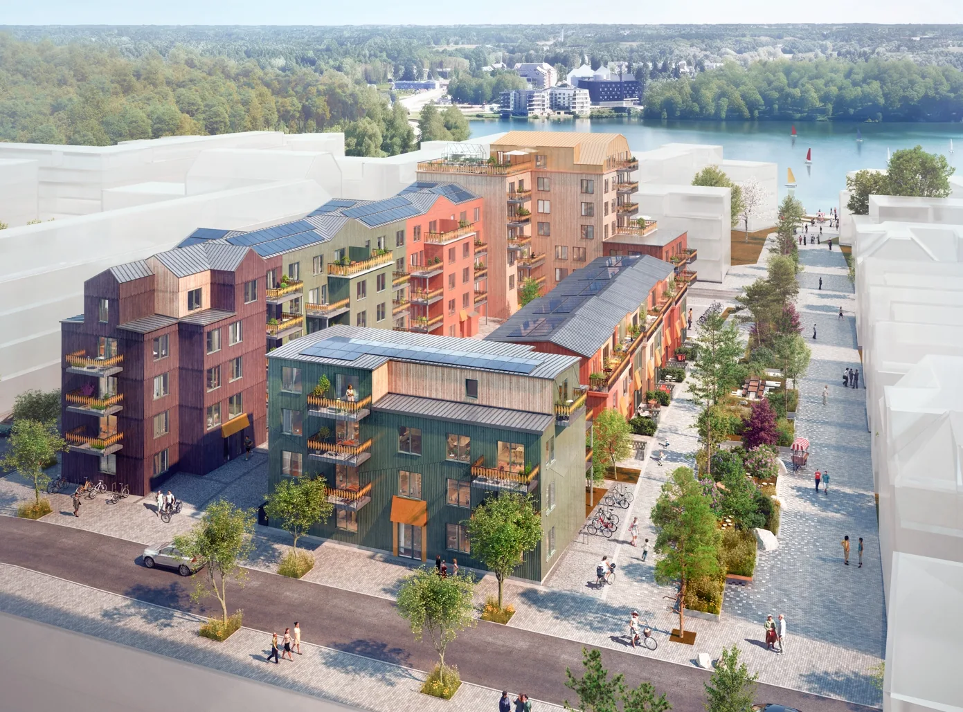 VYN at Väsjö Torg seen from above — timber façades in warm tones, solar panels on the roofs and Lake Väsjön beyond.